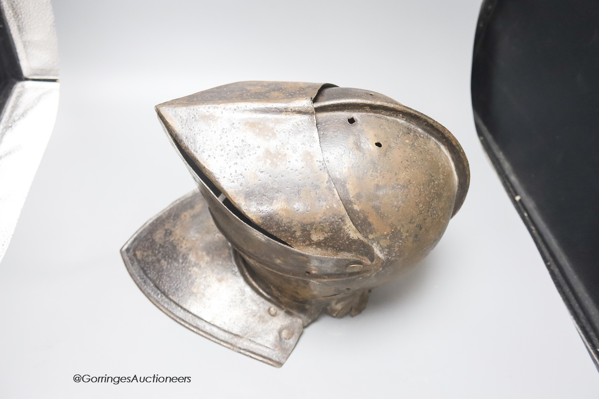 A 17th century iron close helmet, height 28cm approx.